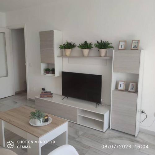 a living room with a flat screen tv on a wall at Apartamento a 9 min centro in Fuengirola