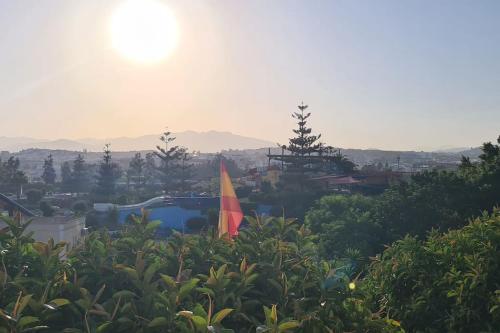 a view of a resort with the sun in the background at Apartamento a 9 min centro in Fuengirola