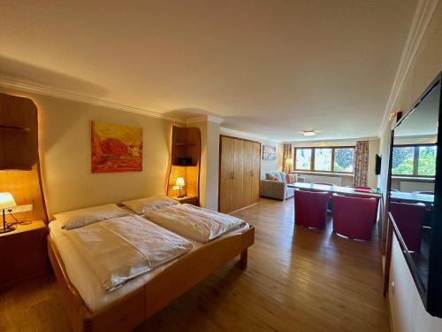 a bedroom with a bed and a living room at Lexenhof in Nussdorf am Attersee