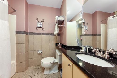 a bathroom with a sink and a toilet and a mirror at Lake Views at The Shores Great Location in Traverse City