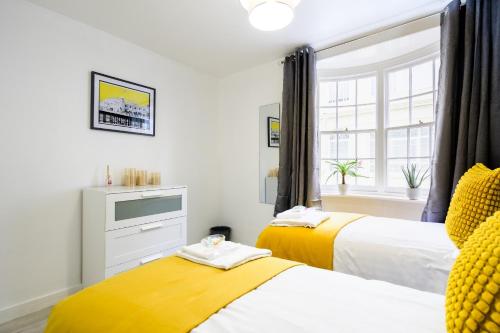 a bedroom with two beds and a window at The Monopoly Breeze House - Your Dream Getaway With Wet Room In The Heart of Brighton in Brighton & Hove