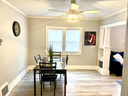 a dining room with a table and chairs and a ceiling fan at Cozy 2 Bedroom Home near Notre Dame in South Bend