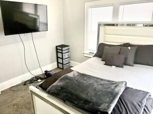 a bedroom with a bed and a flat screen tv at Cozy 2 Bedroom Home near Notre Dame in South Bend
