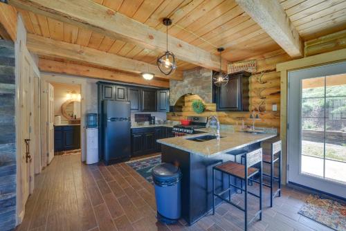 a kitchen with blue appliances and wooden ceilings at Mountain Cabin in Wyoming Range Scenic and Remote! in Kemmerer