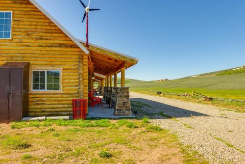 a log cabin in the middle of a field at Secluded Mountain Getaway in Wyoming Range! in Kemmerer