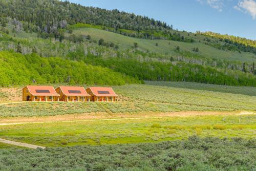 a house in the middle of a field at Secluded Mountain Getaway in Wyoming Range! in Kemmerer