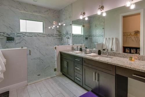 a bathroom with two sinks and a shower at Port Saint Lucie Vacation Rental with Hot Tub! in Port Saint Lucie