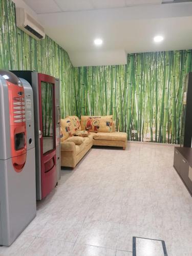 a living room with couches and a room with bamboo curtains at Albergue El Templarin in Ponferrada