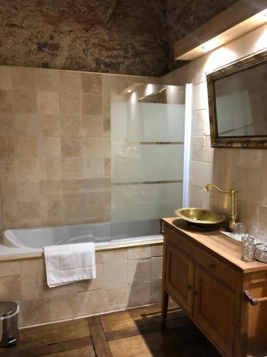 a bathroom with a tub and a sink and a bath tub at Domaine du Très-Haut - Château de Montanges in Montanges
