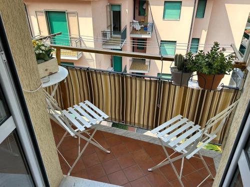 two chairs and a table on a balcony at Relax al mare in Borgio Verezzi