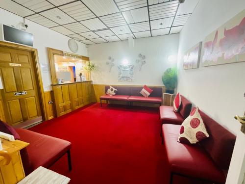 a waiting room with couches and a red carpet at The Danescourt in Blackpool