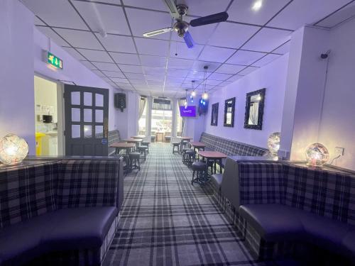a dining room with purple walls and tables and chairs at The Danescourt in Blackpool