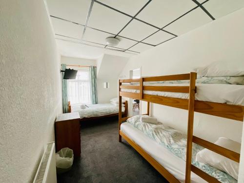 a room with two bunk beds in it at Danescourt Lodge in Blackpool