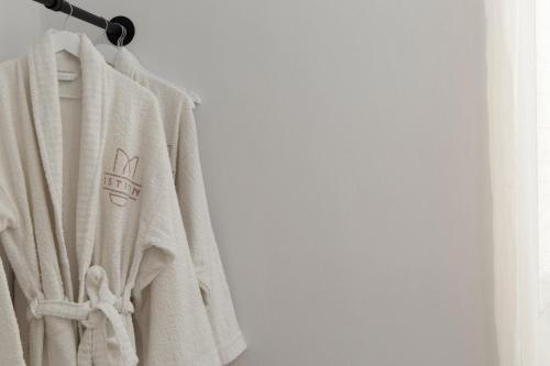a white sweater hanging on a rack at ISTION ANDROS LUXURY SUITES in Andros