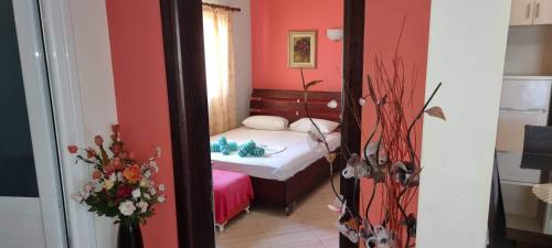 a reflection of a bedroom with a bed in a mirror at Vila Horizont Ksamil in Sarandë