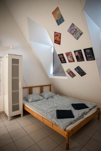 a bedroom with a bed with pictures on the wall at C2 apartman in Siófok