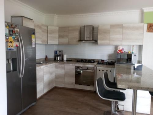 a kitchen with a stainless steel refrigerator and a stove at Beautiful & Central Penthouse in Quibdó in Quibdó