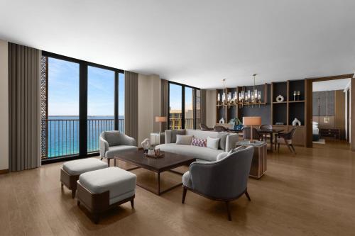a living room with a couch and chairs and a table at Sheraton Cebu Mactan Resort in Mactan