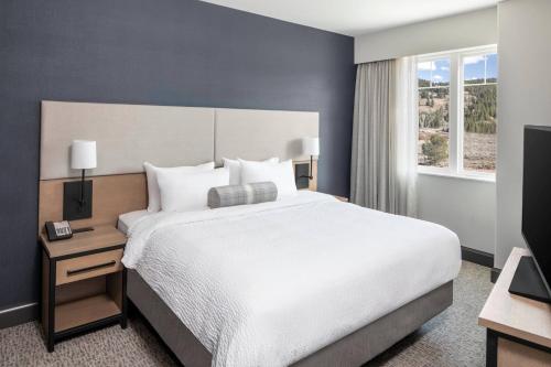 a bedroom with a large bed and a television at Residence Inn by Marriott Big Sky/The Wilson Hotel in Big Sky
