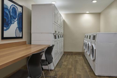 a laundry room with white washers and dryers at Residence Inn by Marriott Big Sky/The Wilson Hotel in Big Sky