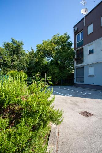 a parking lot in front of a building at Apartment Sladic in Sisak