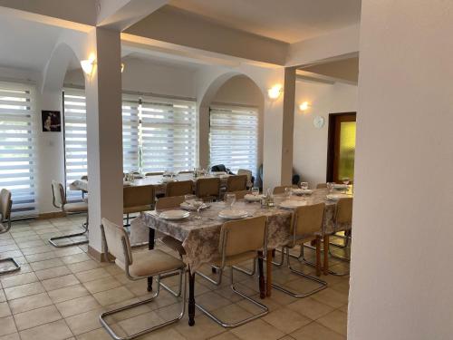a large dining room with a long table and chairs at B&B Family OSTOJIĆ in Međugorje