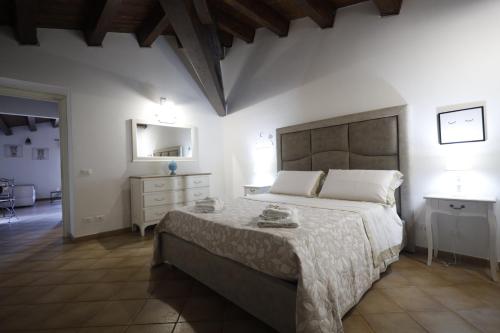 a bedroom with a large bed and a dresser at La Casa di Filippo in Palermo