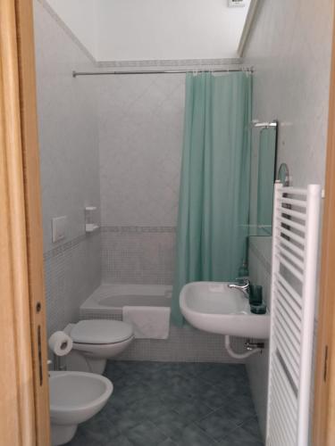 a bathroom with a sink and a toilet and a shower at Casa Vacanze Arturo in Bari