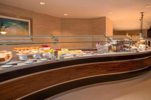 a buffet line with many different types of food at Tulsa Marriott Southern Hills in Tulsa