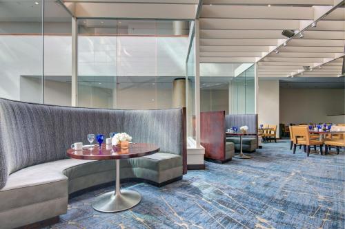 a lobby with a couch and a table at Tulsa Marriott Southern Hills in Tulsa