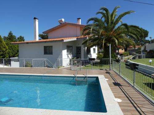 a villa with a swimming pool and a house at Casa do Cabedelo in Viana do Castelo