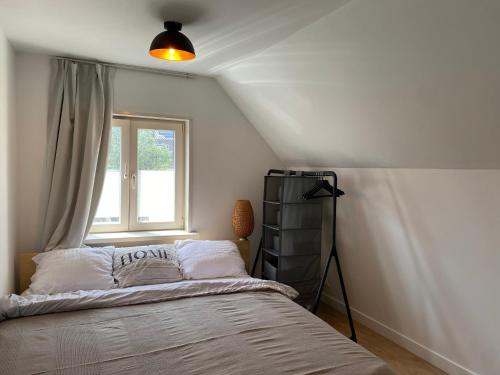 a bedroom with a bed and a window at Beachhouse Wijk aan Zee 6 guests near beach free parking in Wijk aan Zee