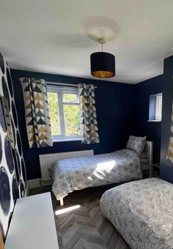 a bedroom with two beds and a window at Spacious Semi-detached Southsea House, Free Parking On Drive in Portsmouth