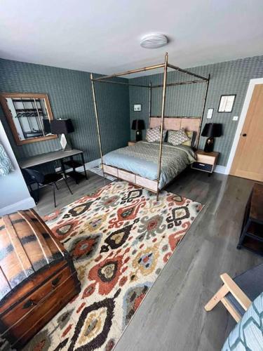 a living room with a bed and a rug at Spacious Semi-detached Southsea House, Free Parking On Drive in Portsmouth