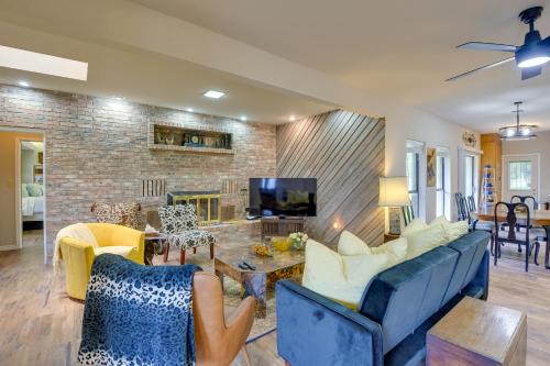 a living room with blue couches and a brick wall at Serene Buffalo Gap Oasis on 4 Secluded Acres! in Abilene