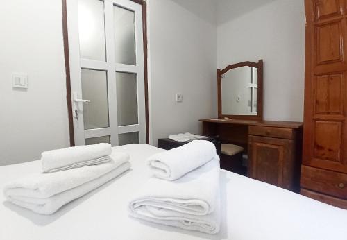 a bathroom with white towels on a bed with a mirror at Daidala Life in Fethiye