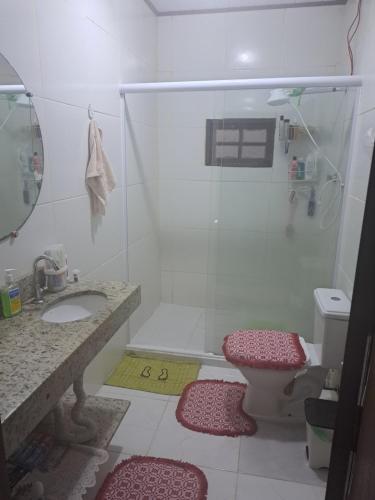 a bathroom with a shower and a sink and a toilet at Casa Aconchegante in Paraty