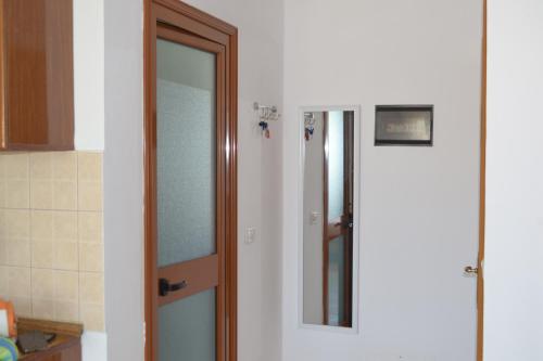 a bathroom with a glass door and a mirror at Studio Apartment Golem in Golem