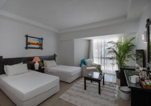 a living room with a bed and a couch at Olives at Santa Monica in Marsa Matruh