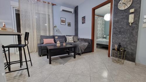 a living room with a couch and a table at Tilemachos central apartment in Alexandroupoli