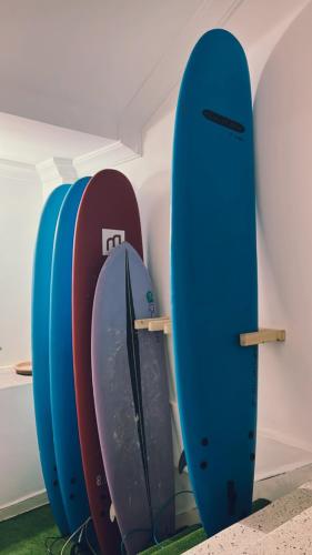 three surfboards are lined up against a wall at cactus surf house in Tamraght Ouzdar