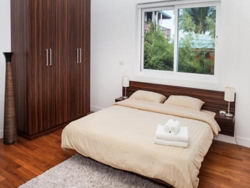 a bedroom with a large bed with a window at Villa Sea Shore SDV184-By Samui Dream Villas in Choeng Mon Beach
