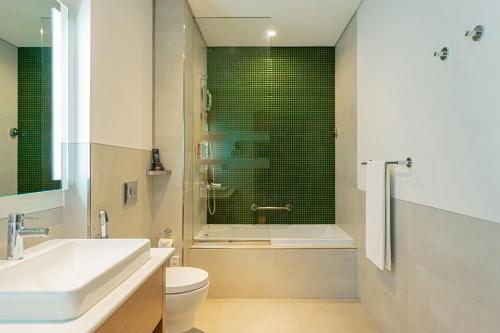a bathroom with a sink and a toilet and a shower at Element Me'aisam, Dubai in Dubai