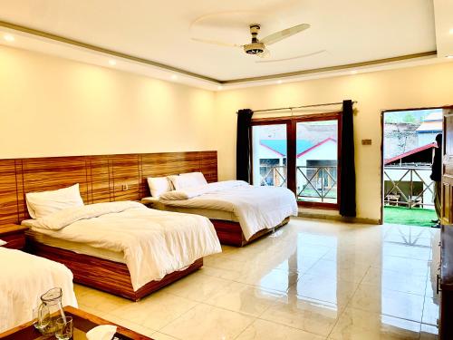 A bed or beds in a room at Grand cottages kalam
