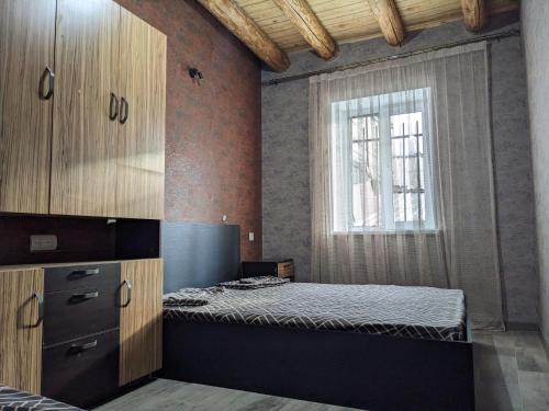 a bedroom with a bed and a window at Sundukyan Apartments in Gyumri