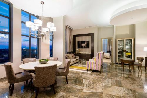 a living room with a table and chairs at Delta Hotels by Marriott Burnaby Conference Centre in Burnaby