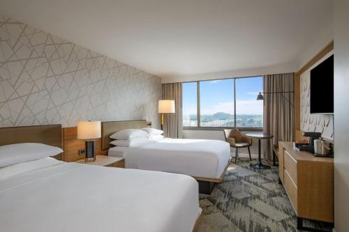 a hotel room with two beds and a television at Sheraton Birmingham in Birmingham