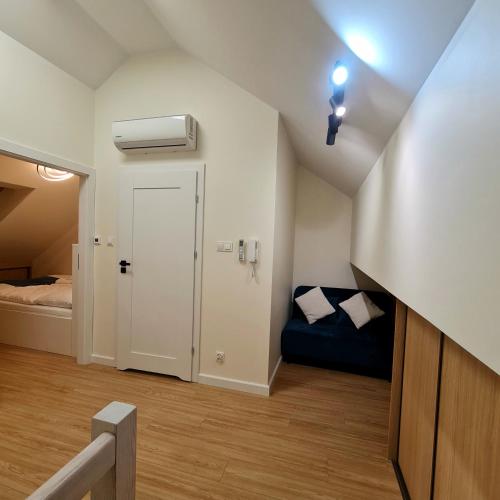 a small room with a door and a bed at Apartament Mierzeja LUX Baltic Garden Basen Swimming pool in Sztutowo