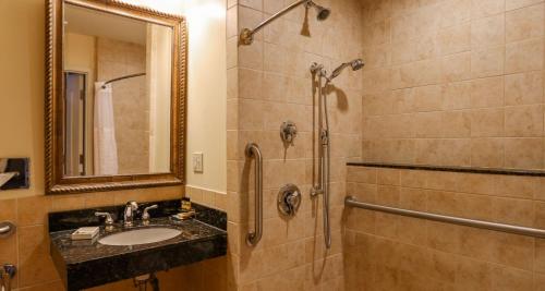 a bathroom with a sink and a shower at Best Western PLUS Vineyard Inn and Suites in Penn Yan