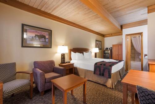 a hotel room with a bed and chairs and a table at Best Western Plains Motel in Wall